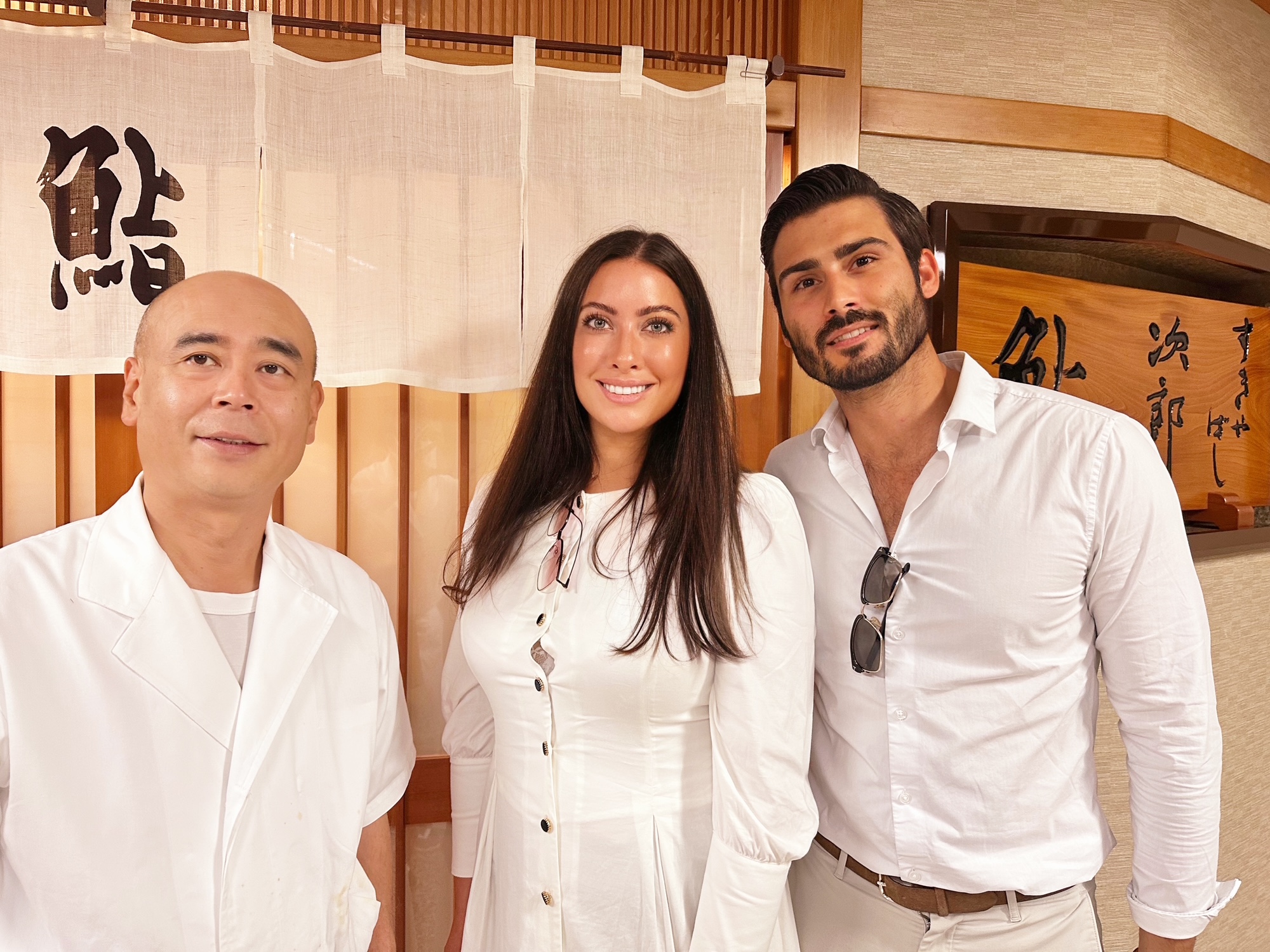 Nikki and Ryan posing with Chef Yoshikazu outside Sukiyabashi Jiro after the meal